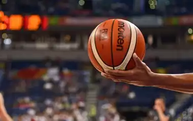 A ref holding a basketball NBA draft 2024