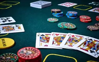 Poker Cards on a table with betting chips around them