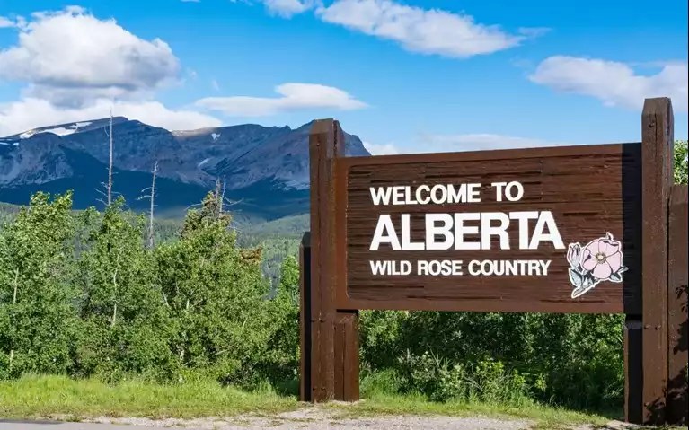 A sign welcoming people to Alberta Canada